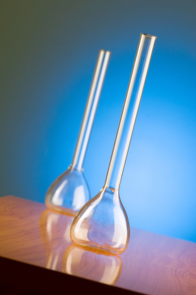 Glass retorts against blue gradient - Foto, afbeelding