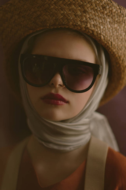 Young beautiful blonde girl in a straw hat - Fotografie, Obrázek
