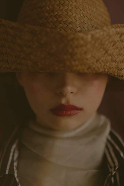 Young beautiful blonde girl in a straw hat - Fotografie, Obrázek