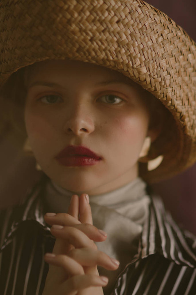 Young beautiful blonde girl in a straw hat - Фото, зображення