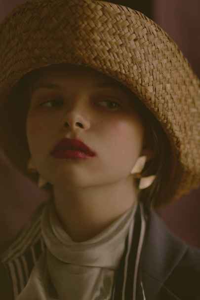 Young beautiful blonde girl in a straw hat - Fotó, kép
