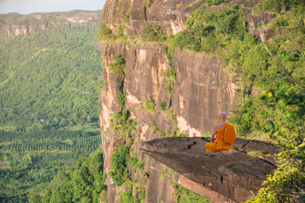 Buddhist monk in meditation at beautiful nature on high mountain - Zdjęcie, obraz
