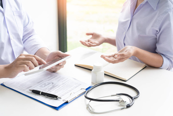 Doctor explaining and giving a consultation to a patient medical informations and diagnosis about the treatment for condition in hospital, medical ethics concept - Photo, Image