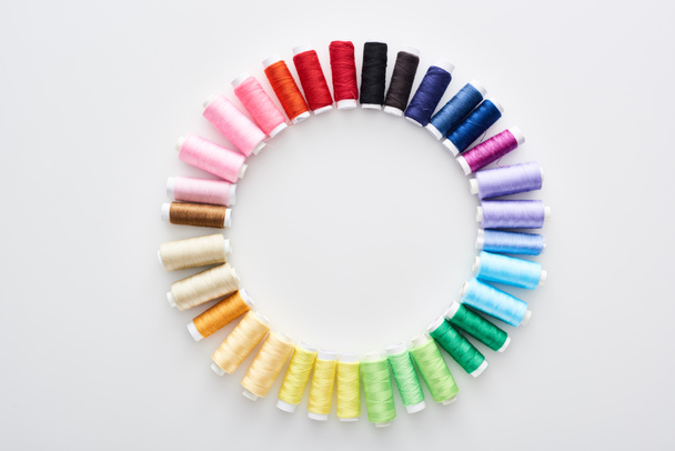 top view of bright and colorful threads on white background  - Foto, afbeelding