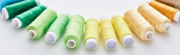 panoramic shot of bright and colorful threads on white background  - Photo, image