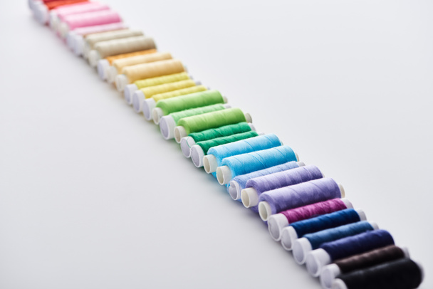 селективный фокус ярких и красочных нитей на белом фоне
  - Фото, изображение