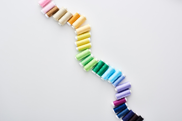 top view of bright and colorful threads on white background  - Foto, Imagem