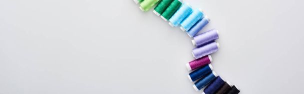 panoramic shot of bright and colorful threads on white background  - Foto, immagini