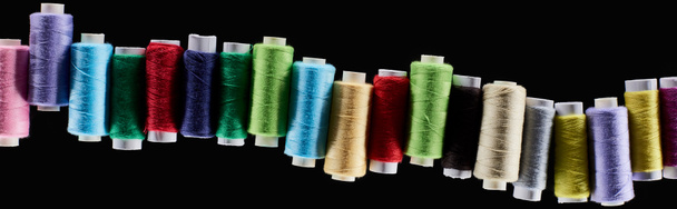 panoramic shot of bright and colorful threads isolated on black - Photo, Image