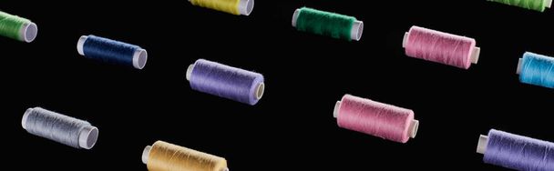 panoramic shot of bright and colorful threads isolated on black - Photo, Image
