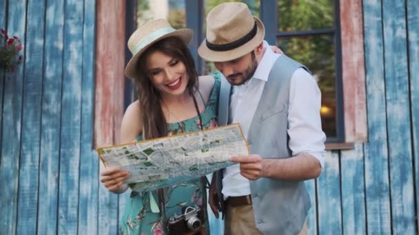 tourists look at the map of the city. couple travelers - Footage, Video