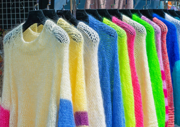 Mohair jackets bright colors on hangers in the store. - Photo, Image