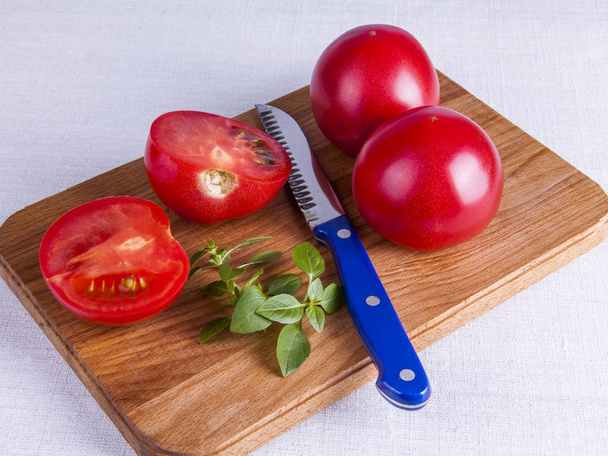 Ingredients for cooking salad from fresh tomatoes and a basil - Fotó, kép