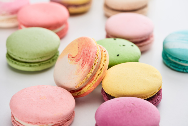 close up view of sweet colorful French macaroons of different flavors on white background, panoramic shot - Fotoğraf, Görsel