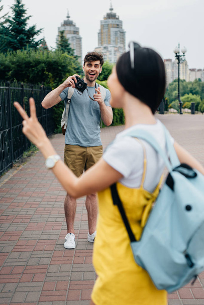 selective focus of handsome man taking photo of brunette woman - Photo, Image