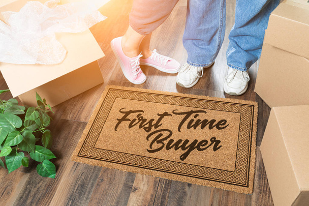 Man and Woman Unpacking Near Our First Time Buyer Welcome Mat, Moving Boxes and Plant - Fotoğraf, Görsel