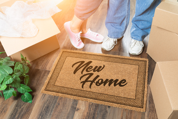 Man and Woman Unpacking Near New Home Welcome Mat, Moving Boxes and Plant - Photo, image