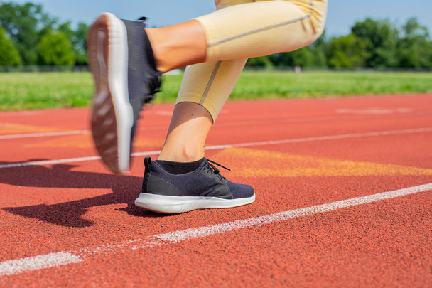 Close-up feet of woman on track, runner on running lane - Foto, Imagem