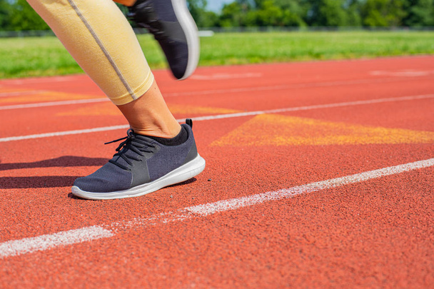 Close-up feet of woman on track, runner on running lane - Foto, Imagen