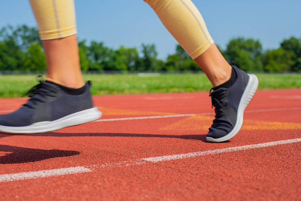 Close-up feet of woman on track, runner on running lane - Фото, изображение