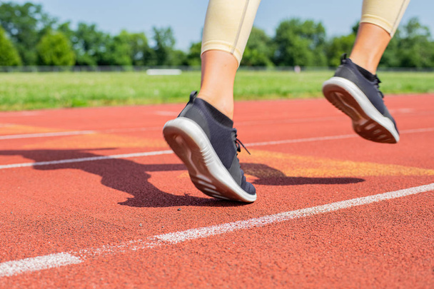 Close-up feet of woman on track, runner on running lane - Фото, изображение