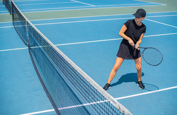 Young sports woman playing tennis on the blue tennis court - Foto, Imagem