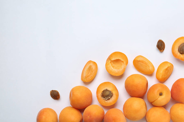 Delicious ripe sweet apricots on white background, top view. Space for text - Photo, Image