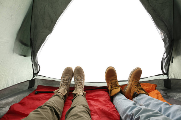 Closeup of couple in camping tent on white background, view from inside - Фото, изображение
