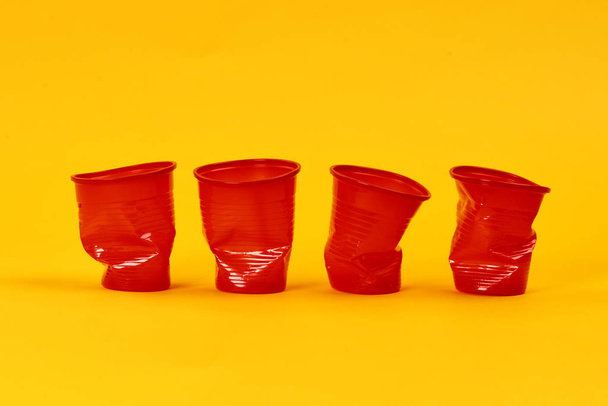 Disposable plastic mugs in a row  - Фото, изображение