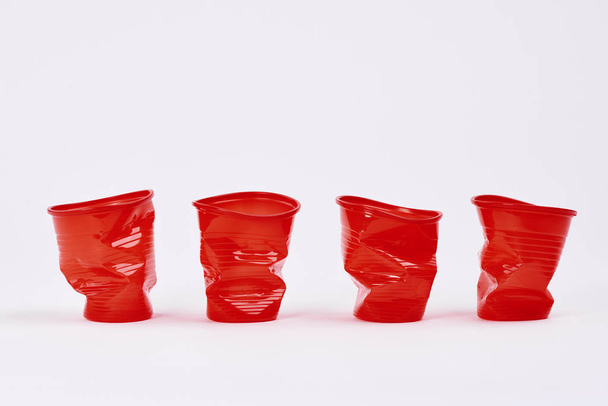 Four disposable plastic cups on white background - Foto, Imagen