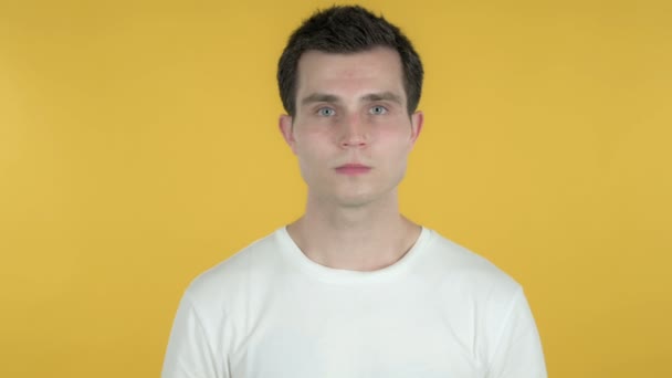 Shocked Young Man Feeling Surprised Isolated on Yellow Background - Materiał filmowy, wideo