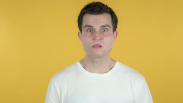 Young Man with Frustration and Anger Isolated on Yellow Background - Video