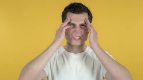 Young Man with Headache Isolated on Yellow Background - Video