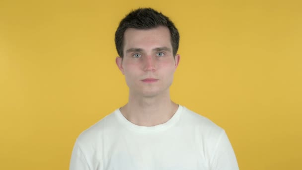 Young Man Pointing at Camera Isolated on Yellow Background - Кадры, видео