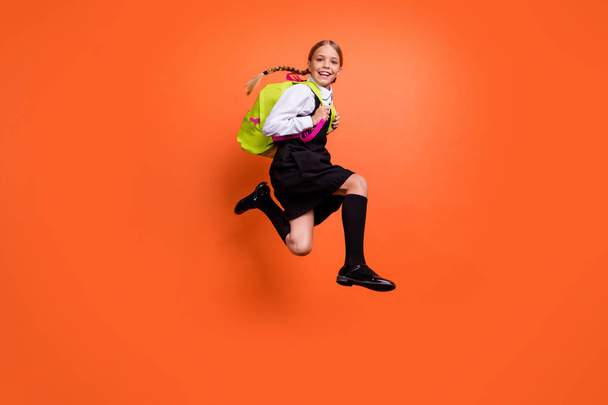 Full length body size view of nice attractive cheerful cheery glad pre-teen girl nerd having fun first grade active motion movement isolated on bright vivid shine orange background - Fotografie, Obrázek