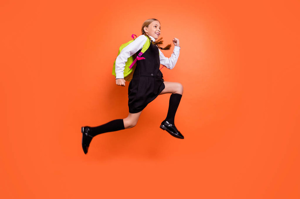 Full length body size view of nice attractive charming lovely cheerful cheery strong purposeful pre-teen girl running fast early morning isolated on bright vivid shine orange background - Фото, зображення