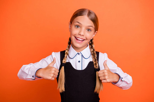 Close-up portrait of her she nice attractive lovely cheerful cheery glad pre-teen girl showing two double thumbup isolated over bright vivid shine orange background - Foto, Bild