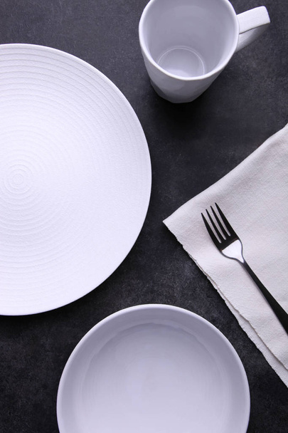 Clean white dishes, fork and kitchen towel  - Photo, Image