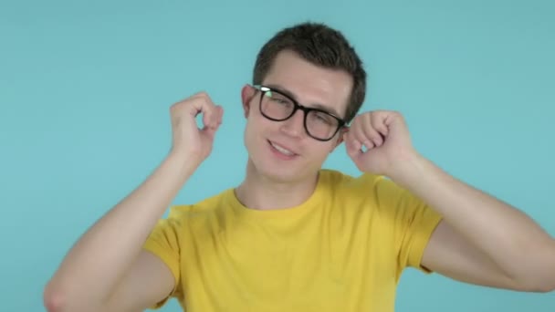 Happy Young Man Dancing Isolated on Blue Background - Video, Çekim