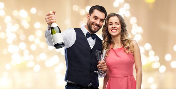 happy couple with bottle of champagne and glasses - Photo, image