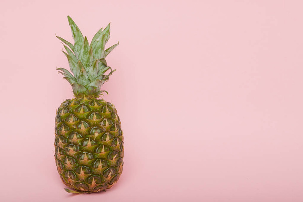 Half cut juicy pineapple on a pastel pink background. Minimal su - Фото, зображення