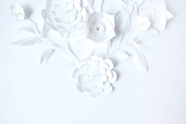 White paper flowers on white background. Cut from paper. - Фото, изображение