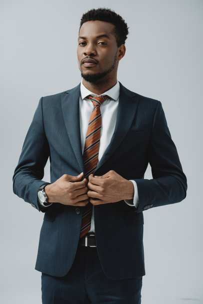 african american man touching suit isolated on grey  - Foto, Imagen