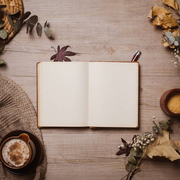Fall mockup old notebook with red pen, autumn leaves, cup of cappuccino and cozy wool scarf. Flat lay, top view. - Fotoğraf, Görsel