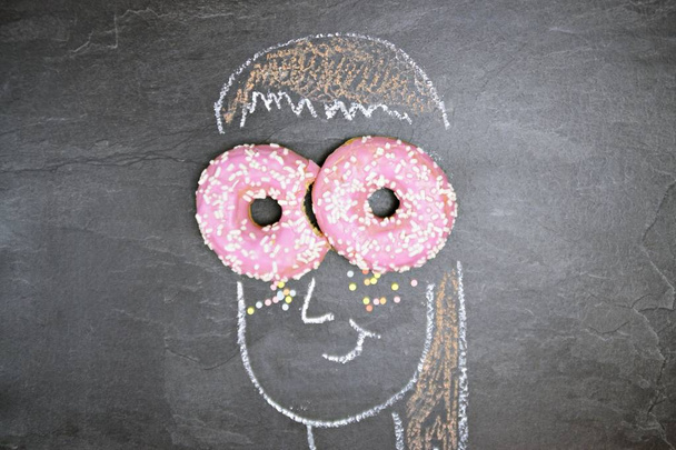 closeup view of chalk draw over blackboard with pastry - Photo, Image