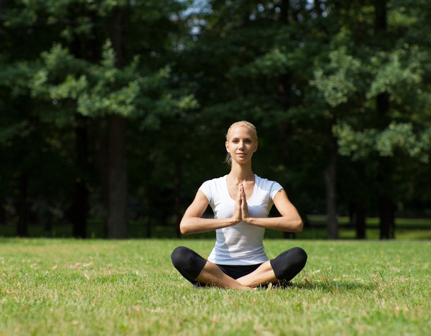 Beautiful woman doing yoga exercises - Photo, image