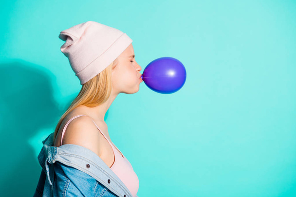 Profile side view portrait of her she nice cute attractive lovely girlish girl blowing violet balloon celebratory festive isolated on bright vivid shine blue green turquoise background - Photo, Image