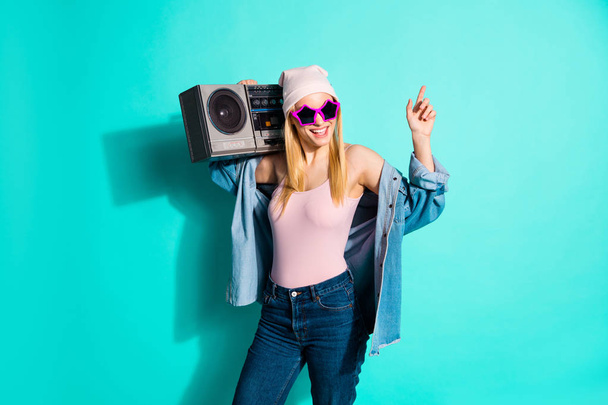 Portrait of her she nice attractive lovely cheerful cheery girl wearing cool eyewear carrying stereo mp3 having fun free time isolated on bright vivid shine blue green turquoise background - Zdjęcie, obraz