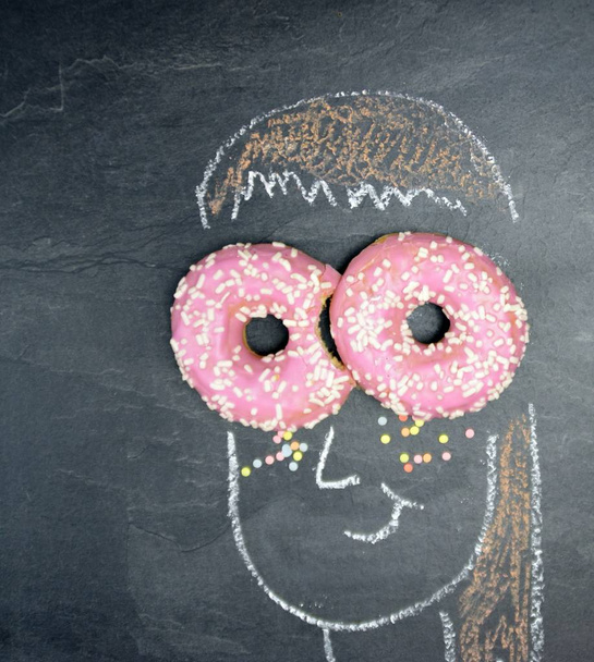 closeup view of chalk draw over blackboard with pastry - Photo, image