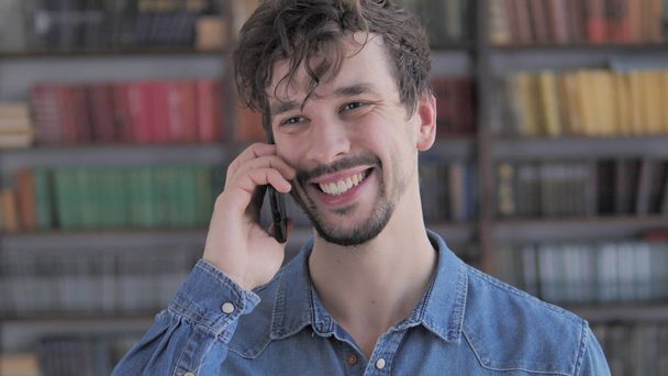 Portrait de jeune homme occasionnel parlant au téléphone
 - Photo, image